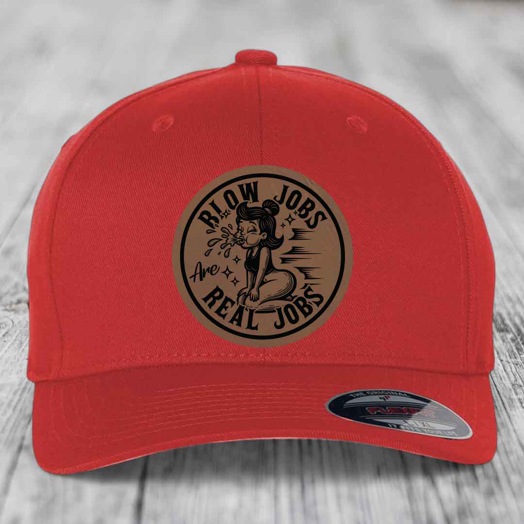 Red baseball cap with circular brown leatherette patch featuring cartoon woman and text &