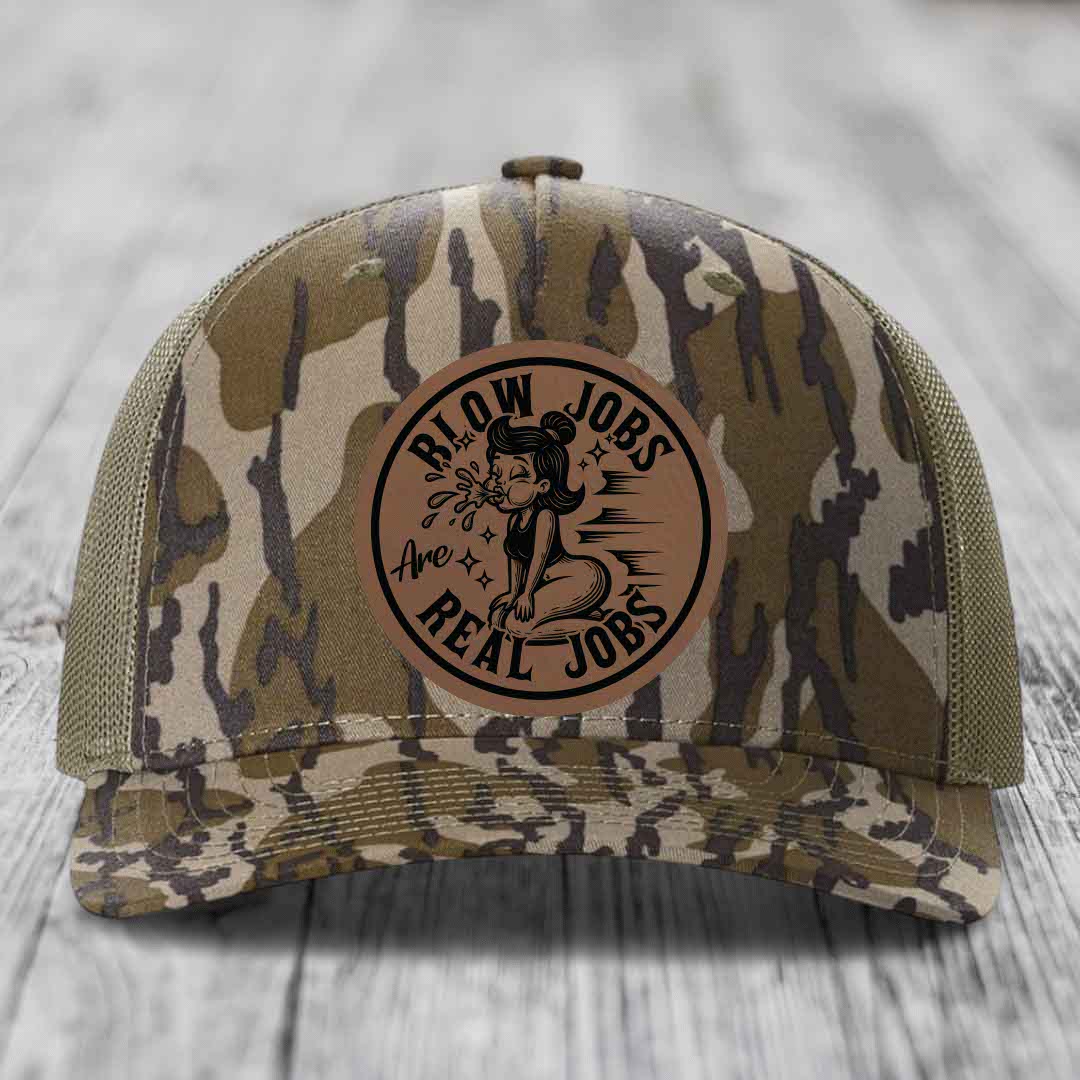 Camouflage trucker hat with brown leather patch reading &