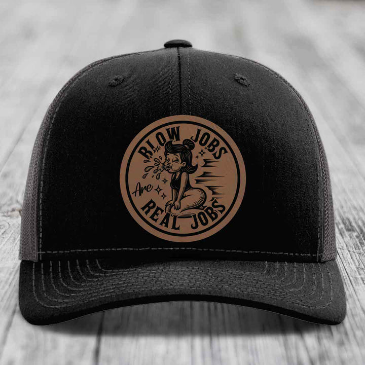 Black trucker hat with brown circular patch reading &