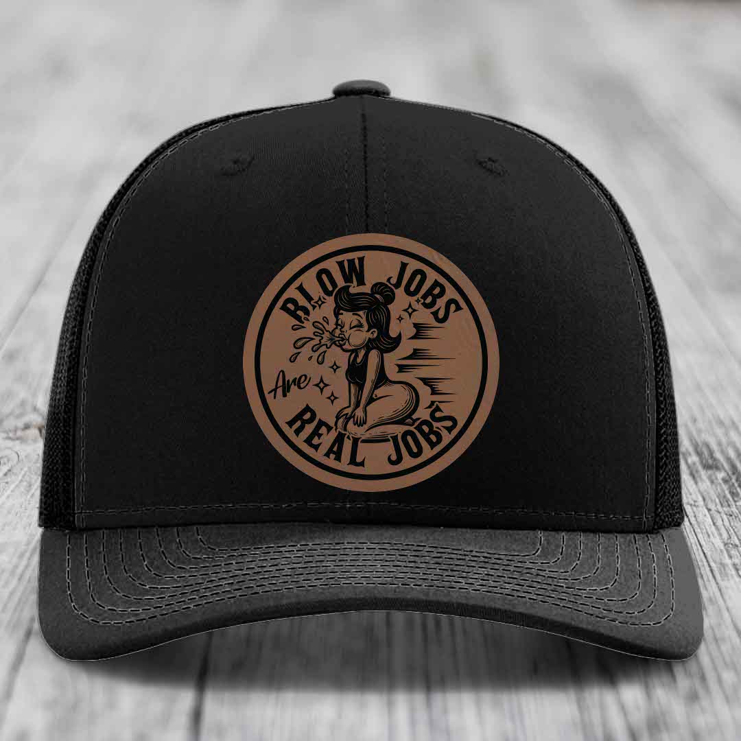 Black trucker hat with brown circular leather patch featuring cartoon woman and text &