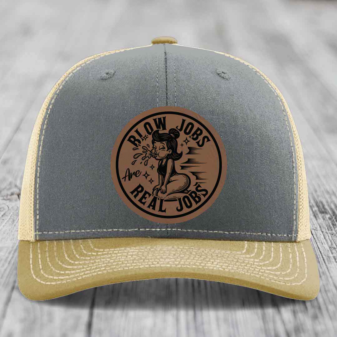 Grey and beige trucker hat with brown leather patch reading &