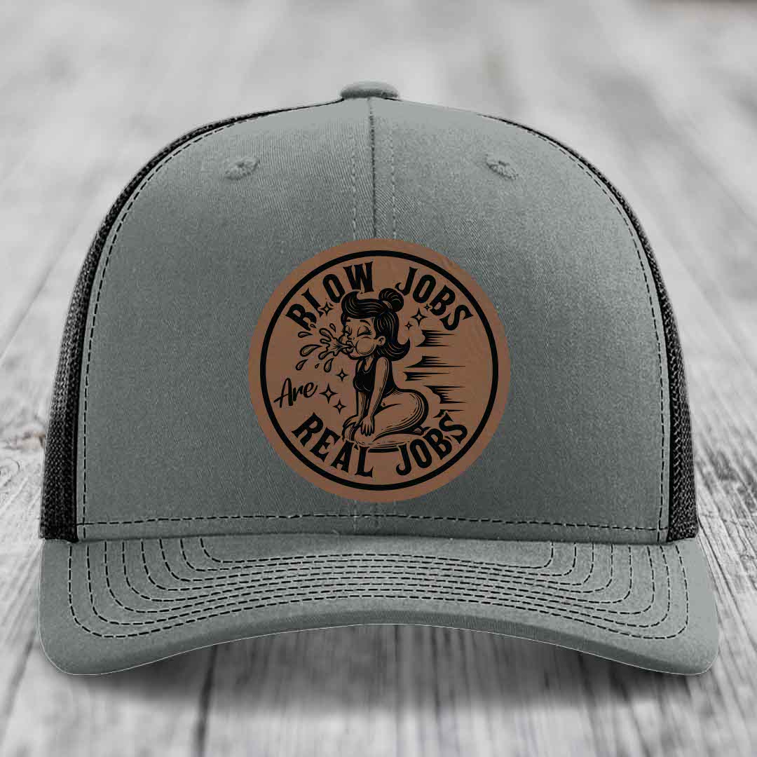 Grey trucker hat with brown leather patch reading &