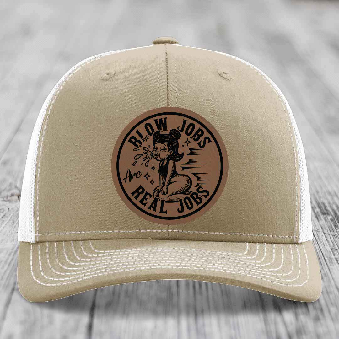 Tan trucker hat with brown leather patch reading &