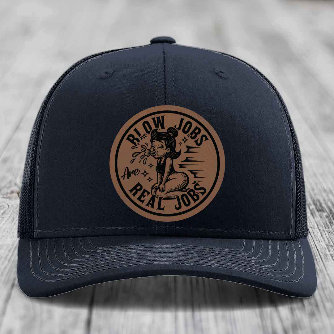 Black trucker hat with brown circular leather patch reading &