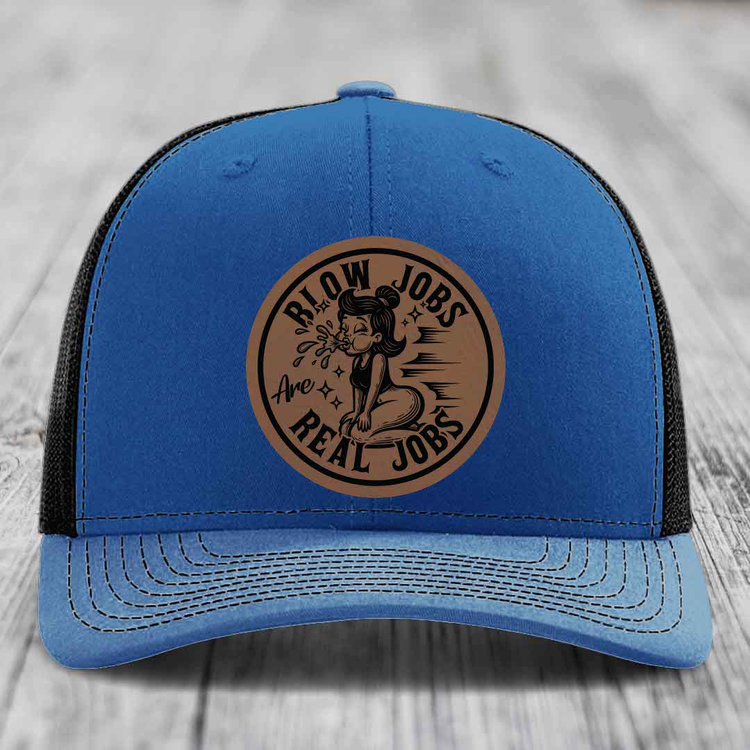 Blue trucker hat with brown circular leather patch reading &