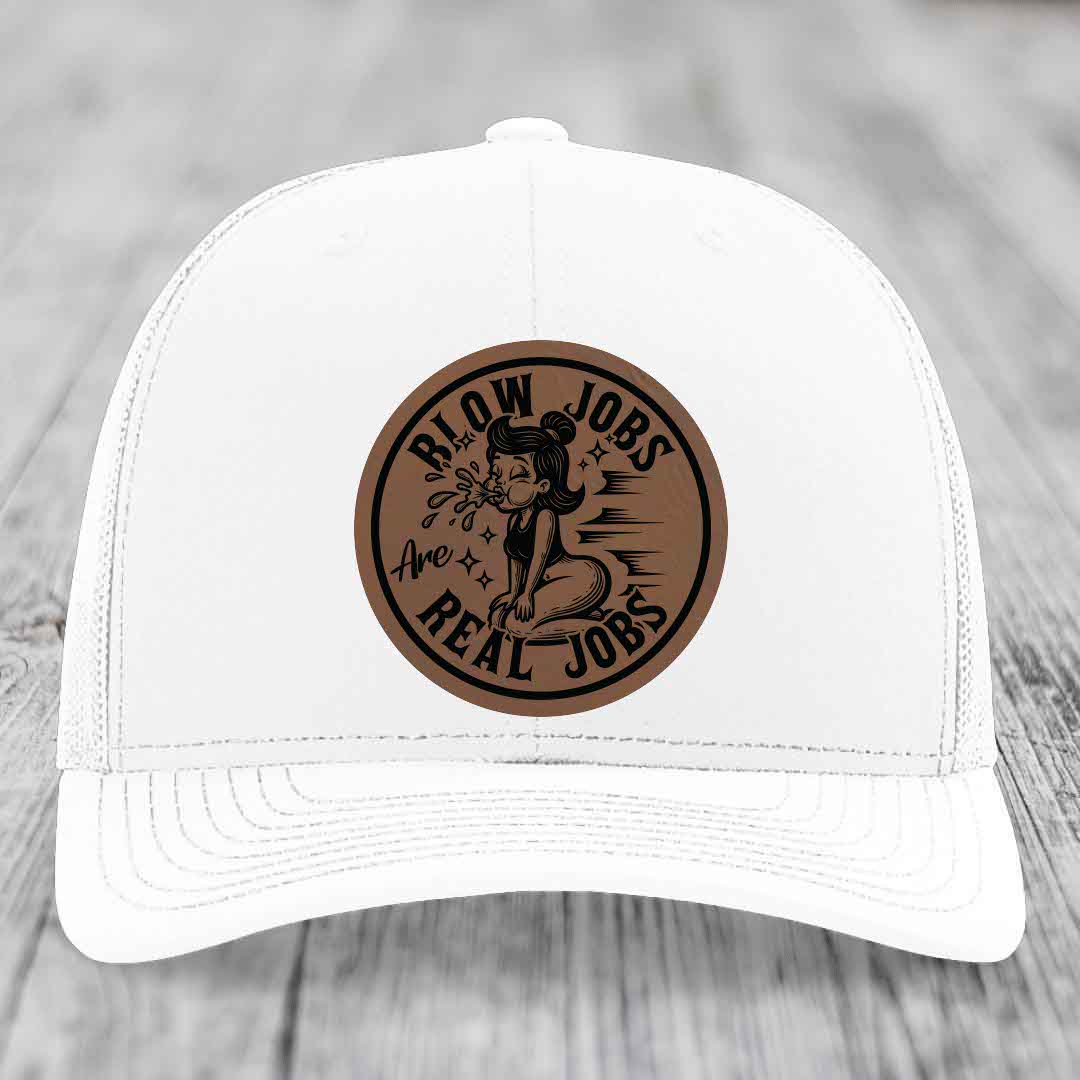 White trucker hat with brown circular leather patch featuring cartoon woman and text &