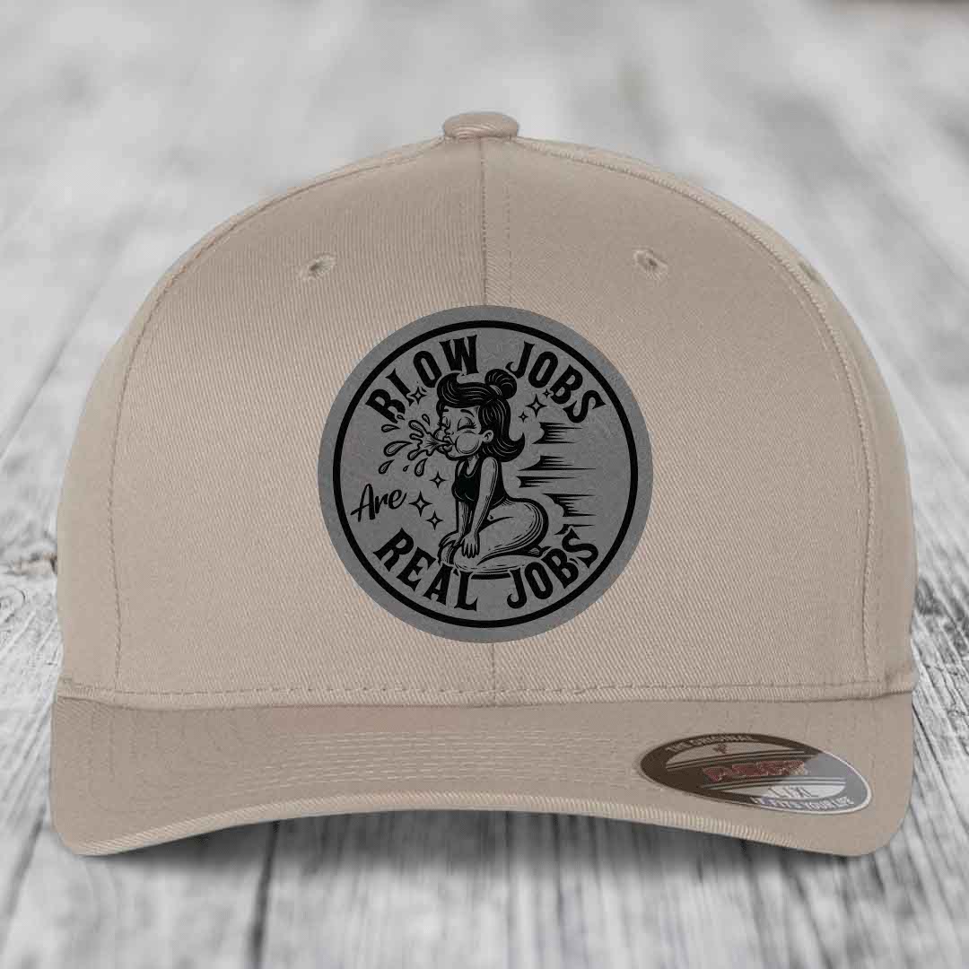 Beige baseball cap with black circular patch reading &