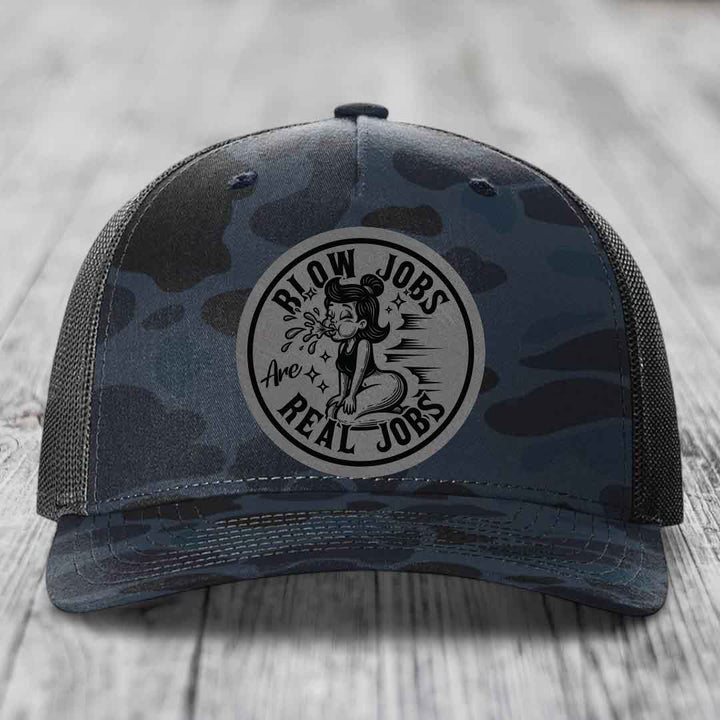 Camouflage trucker hat with a circular patch reading &