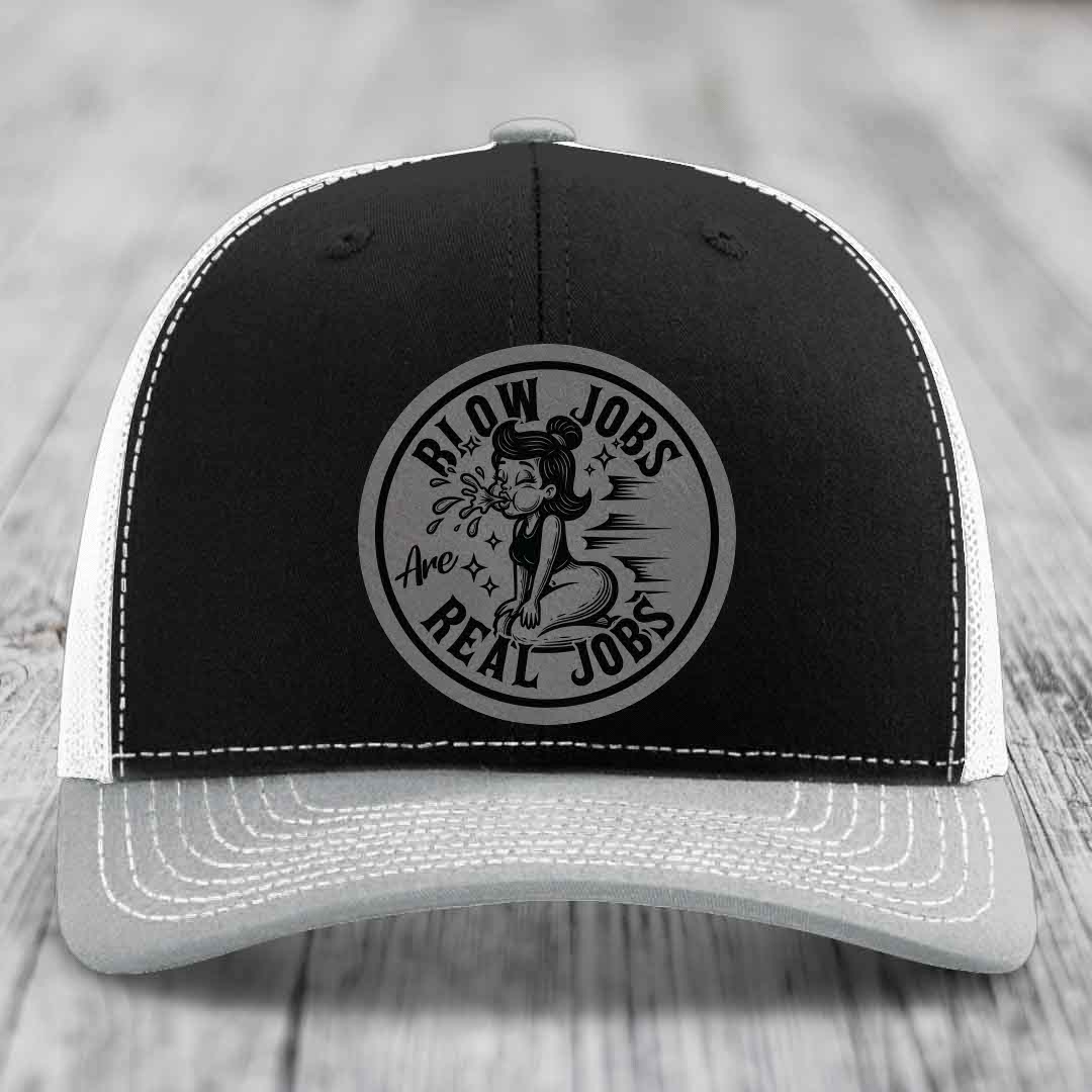 Black and white trucker hat with circular patch reading &