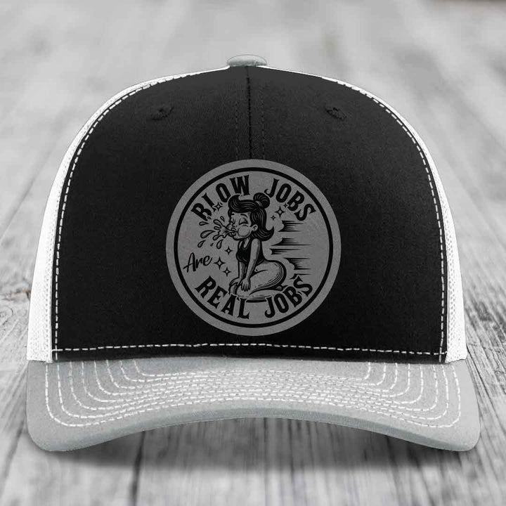 Black and white trucker hat with circular patch reading &