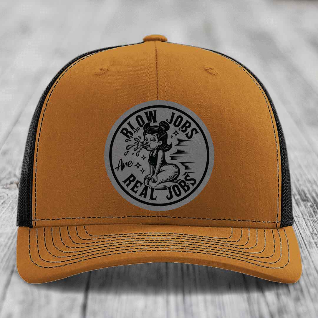 Tan trucker hat with black mesh back and gray circular patch reading &