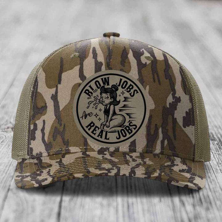 Camouflage trucker hat with a circular patch reading &
