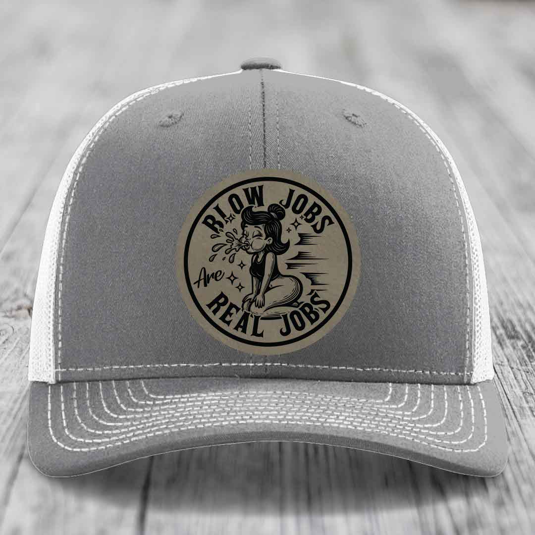 Grey trucker hat with white mesh back and embroidered circular patch reading &