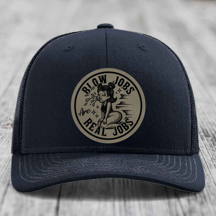 Dark blue trucker hat with beige circular patch reading &