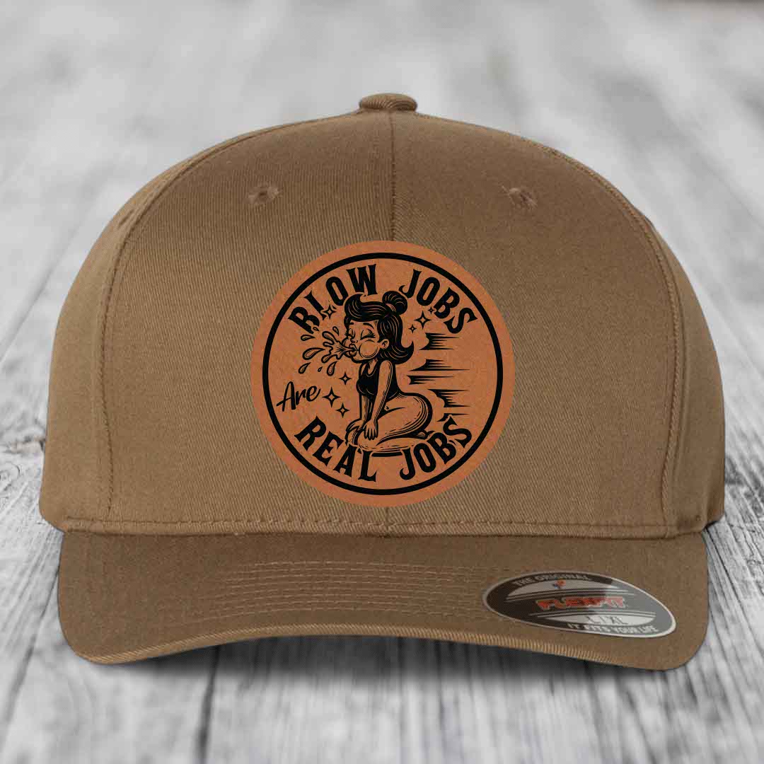 Tan baseball cap with circular brown leather patch featuring cartoon woman and text &