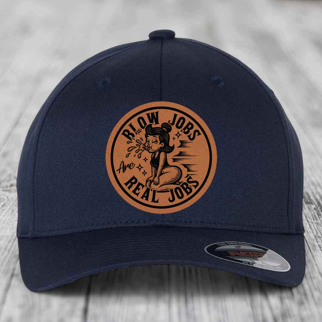 Dark blue baseball cap with circular brown leatherette patch featuring cartoon woman and text &