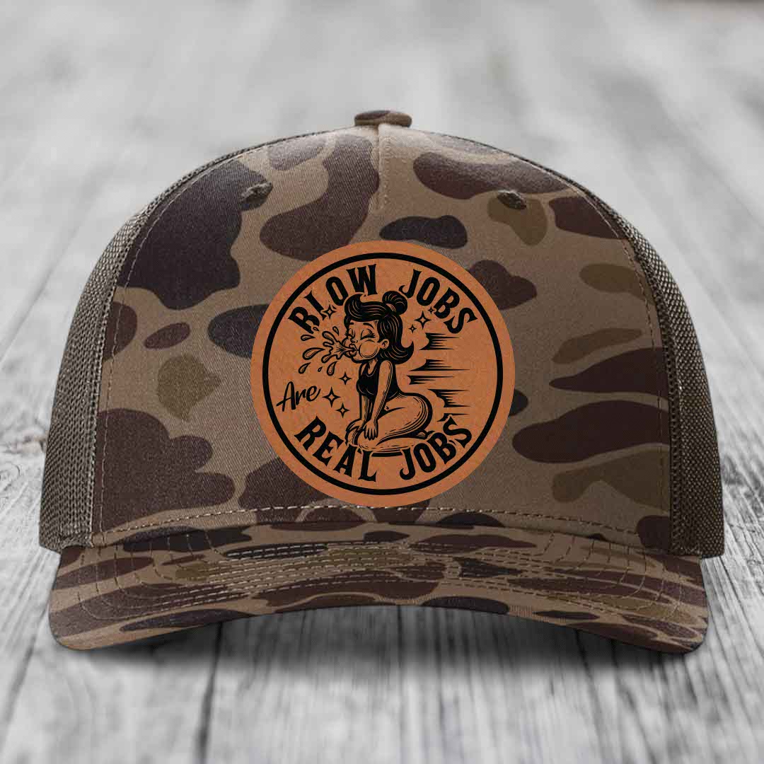 Camouflage trucker hat with brown leather patch reading &