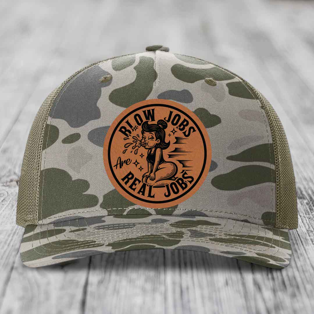 Camouflage trucker hat with brown leather patch reading &