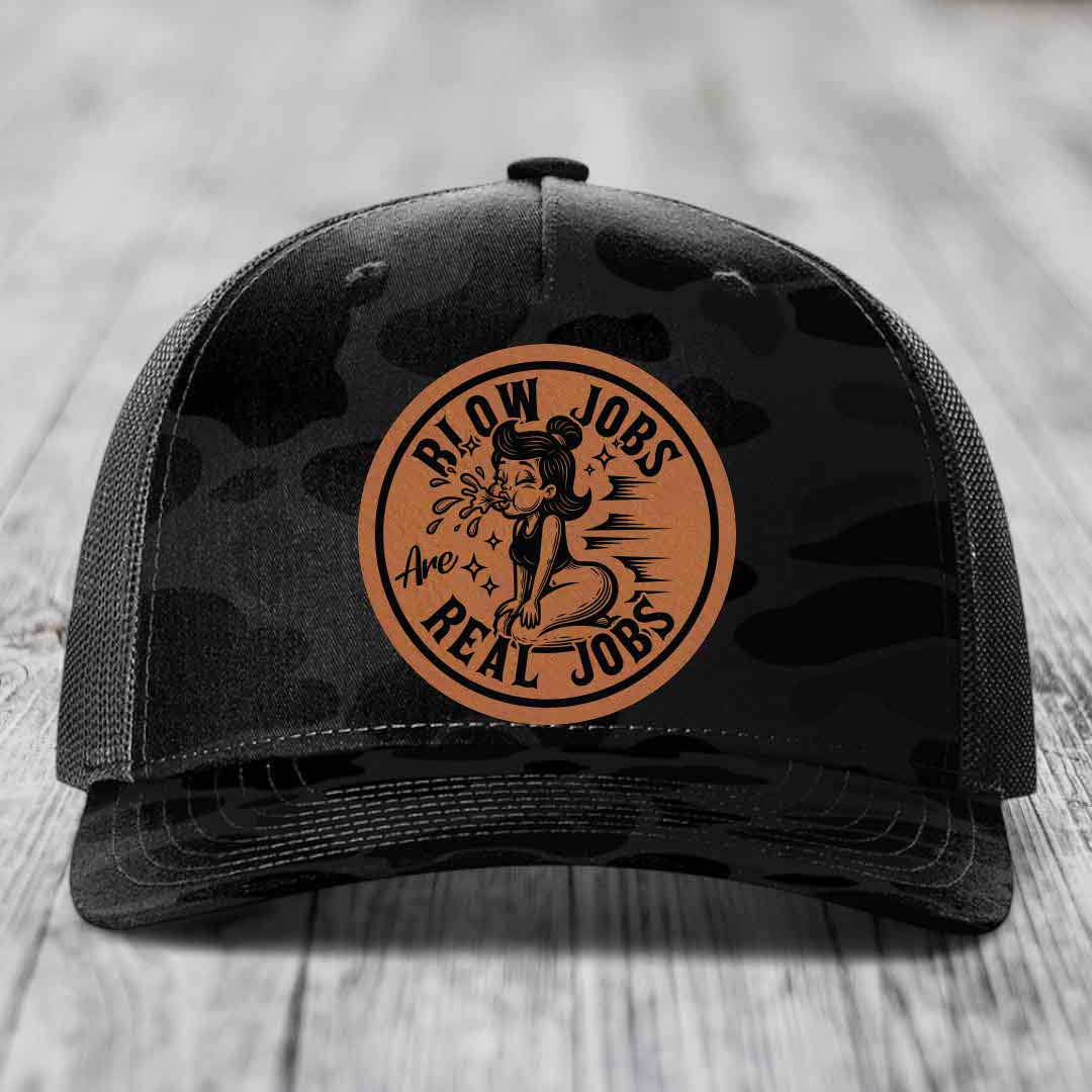Black camouflage trucker hat with brown circular leather patch featuring cartoon woman and text &