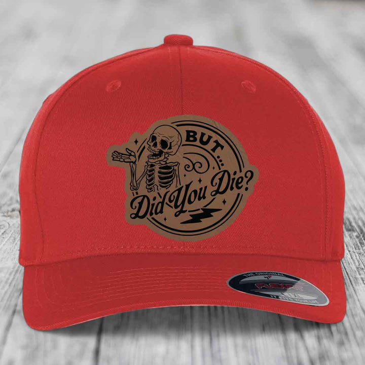 Red baseball cap with a brown leatherette patch featuring a skeleton and the text &