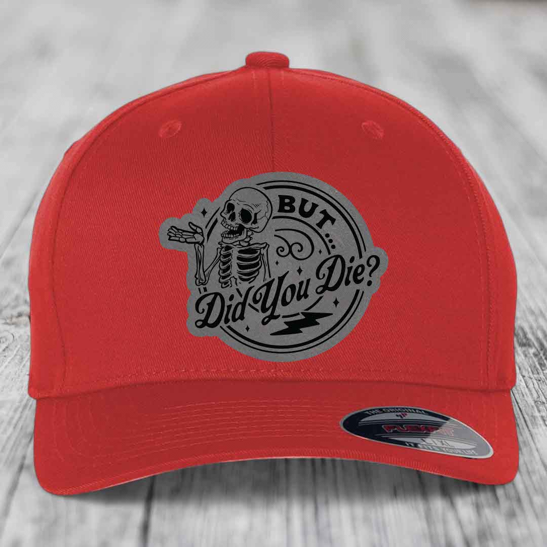 Red baseball cap with grey circular patch featuring a skeleton and text &