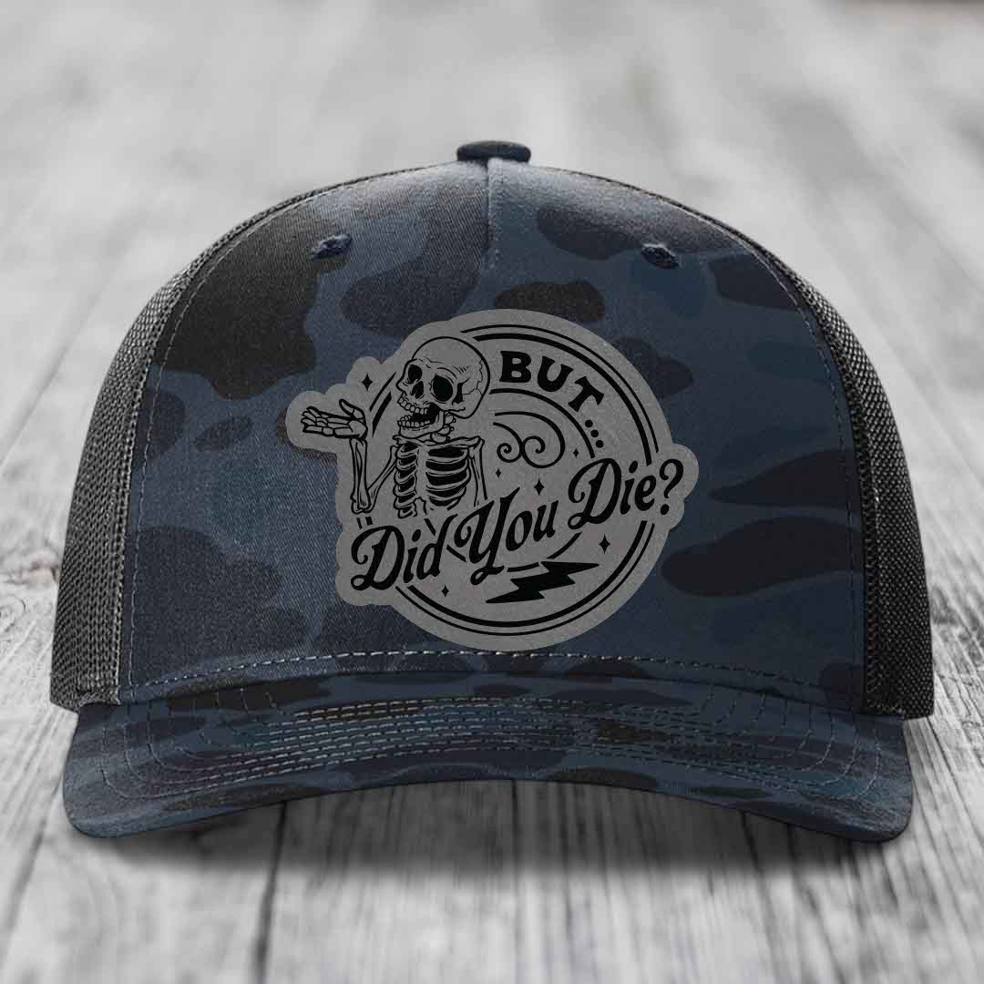 Camouflage trucker hat with skeleton patch reading &