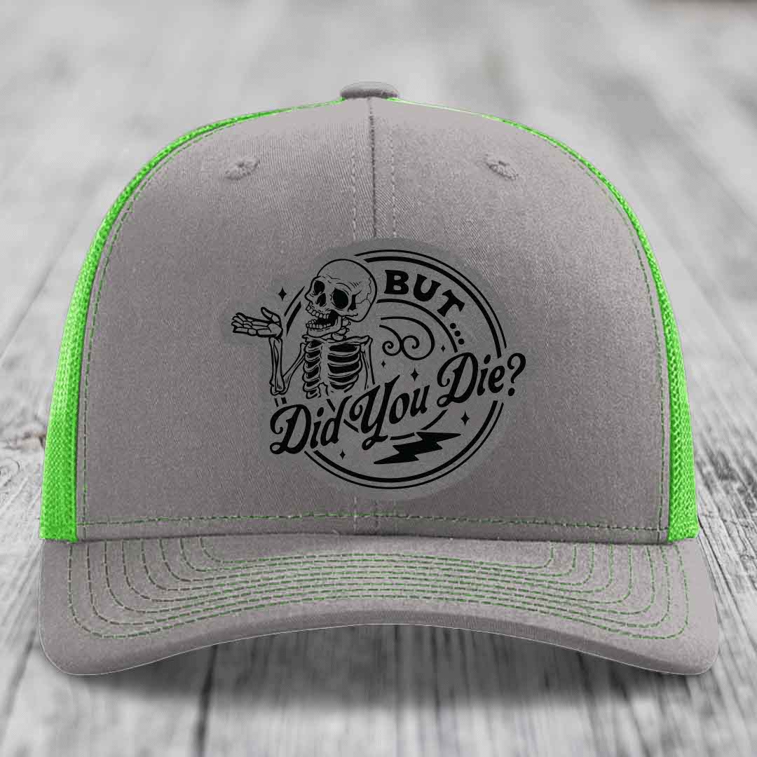 Grey trucker hat with neon green mesh and stitching, featuring a black skeleton graphic and text &