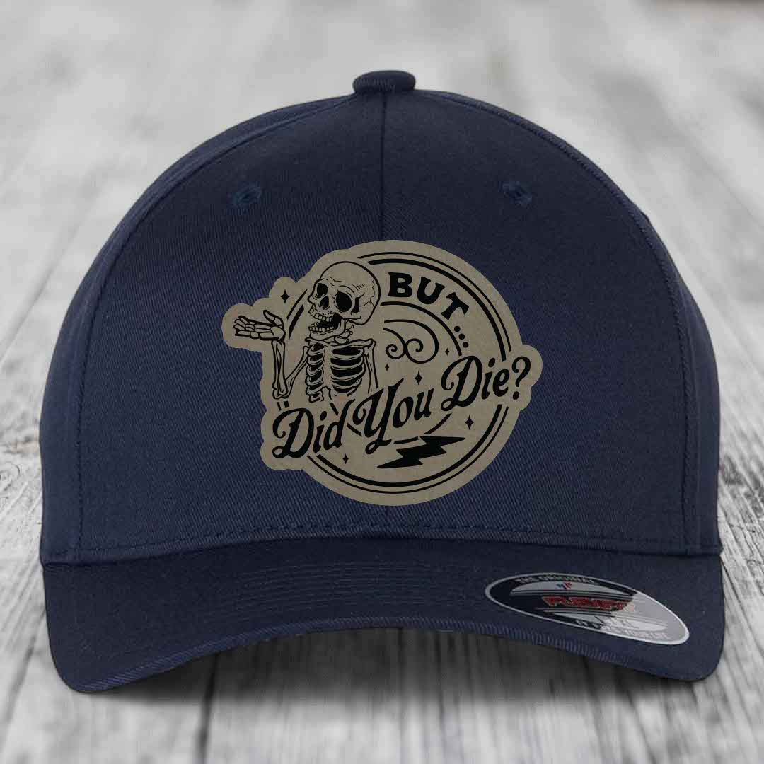 Dark blue baseball cap with a beige circular patch featuring a skeleton and the text &