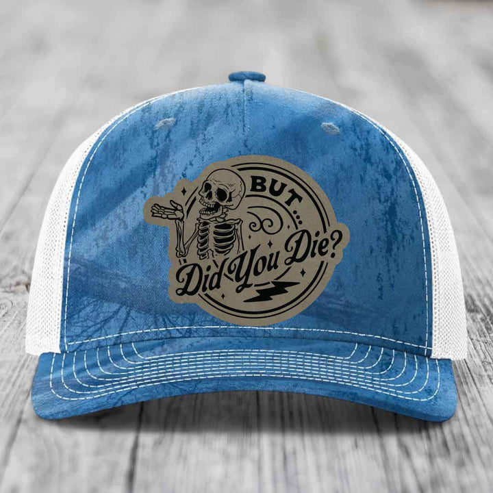 Blue and white trucker hat with a skeleton graphic and text reading &