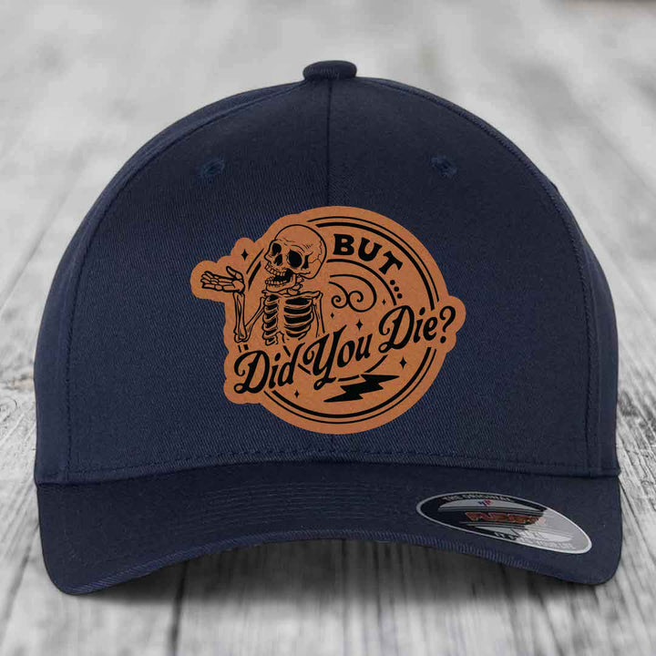 Dark blue baseball cap with a brown leatherette patch featuring a skeleton and the text &