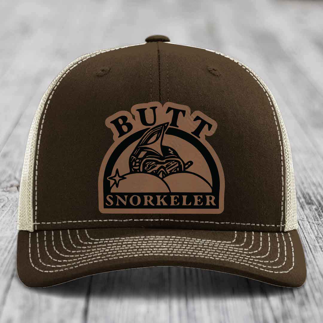 Brown trucker hat with beige mesh back and white stitching, featuring a &