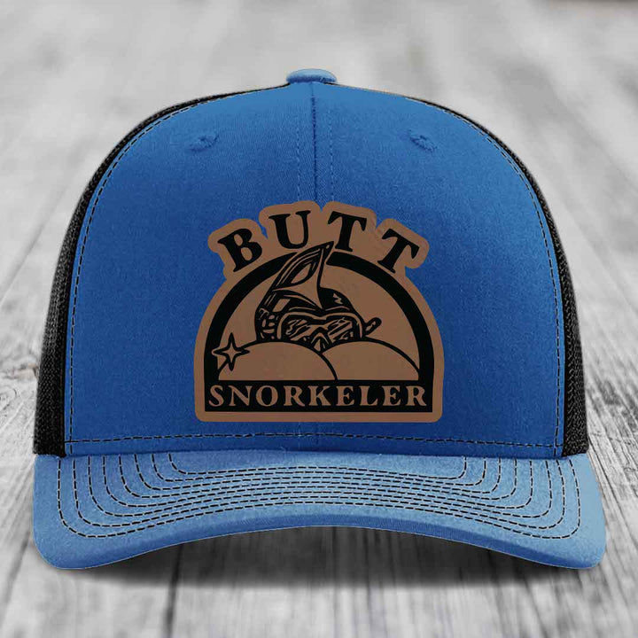 Blue trucker hat with brown leatherette patch reading &
