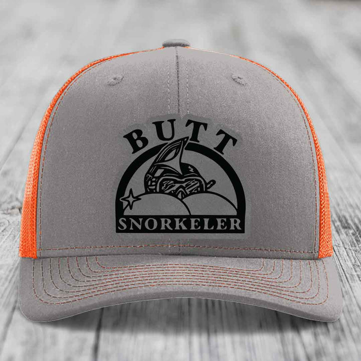 Grey trucker hat with orange mesh back and black &