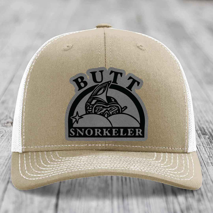 Tan trucker hat with white mesh back and embroidered &