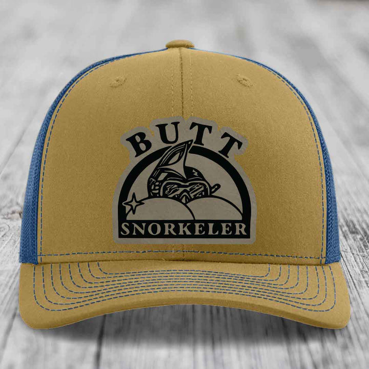 Tan trucker hat with blue mesh back and black embroidered &