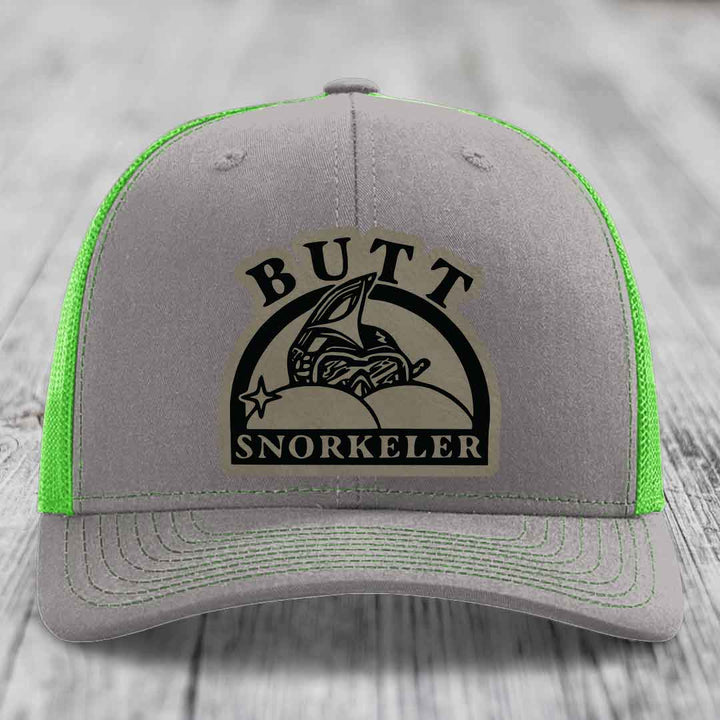 Grey trucker hat with neon green mesh and stitching, featuring a &