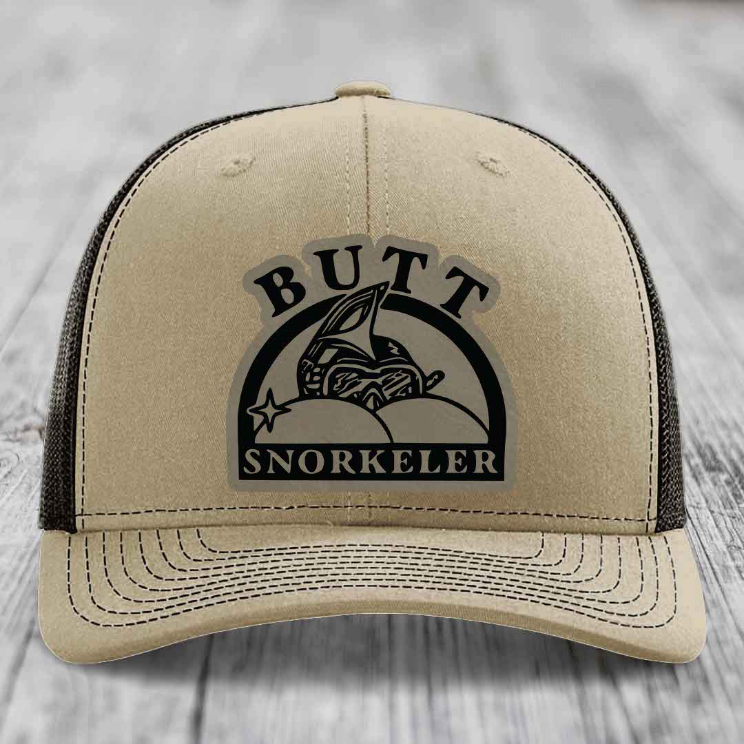 Beige trucker hat with black mesh back and embroidered &