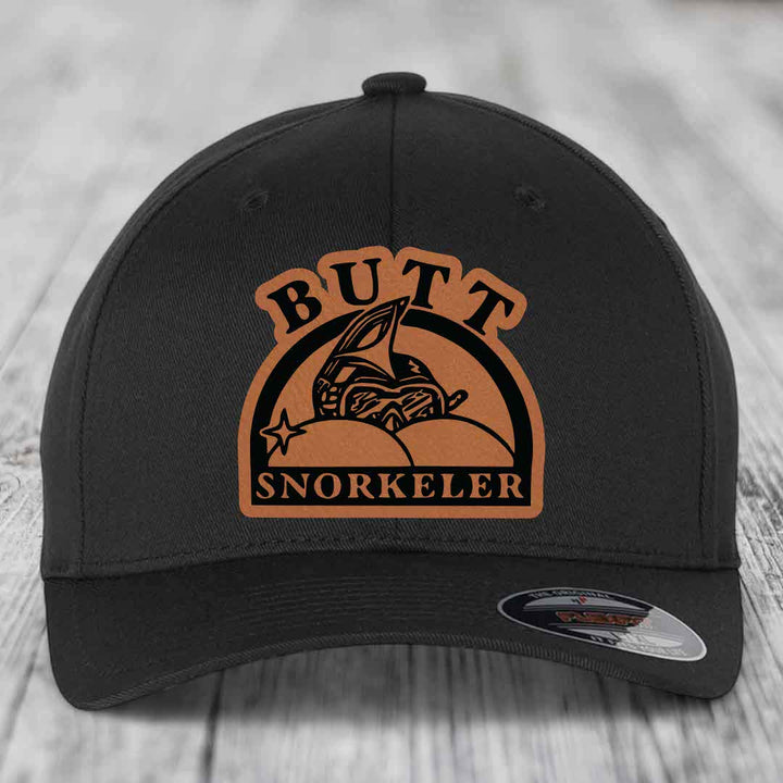 Black baseball cap with brown leather patch reading &