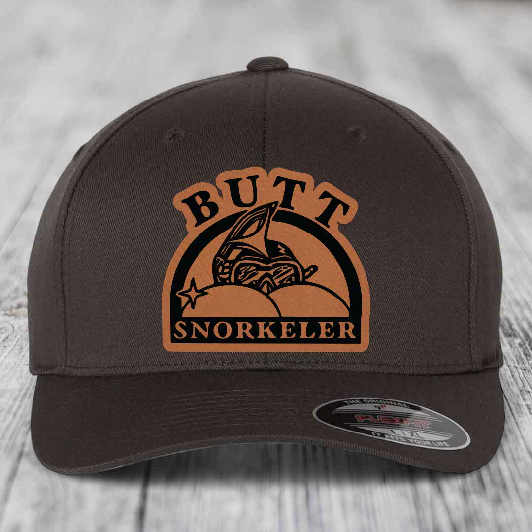 Dark brown Flexfit hat with a tan leatherette patch reading &