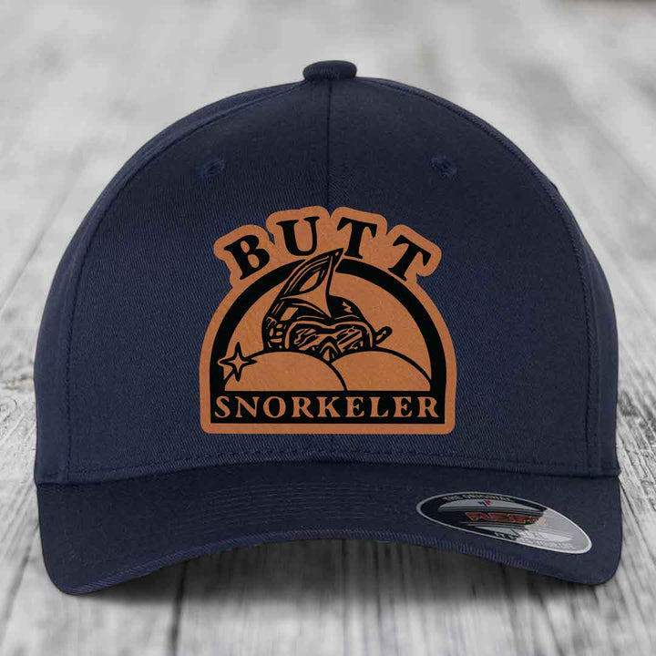 Dark blue baseball cap with brown leatherette patch reading &