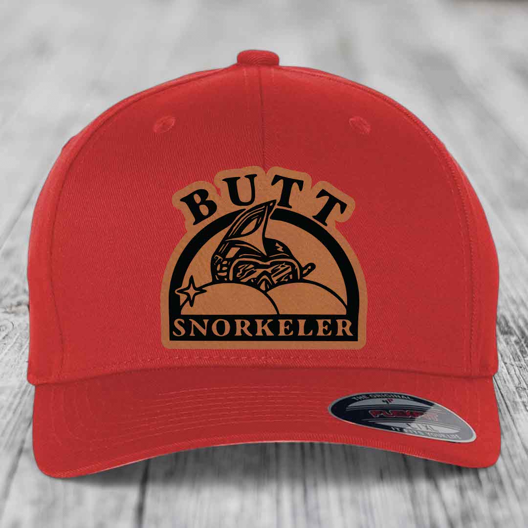 Red baseball cap with brown leatherette patch reading &