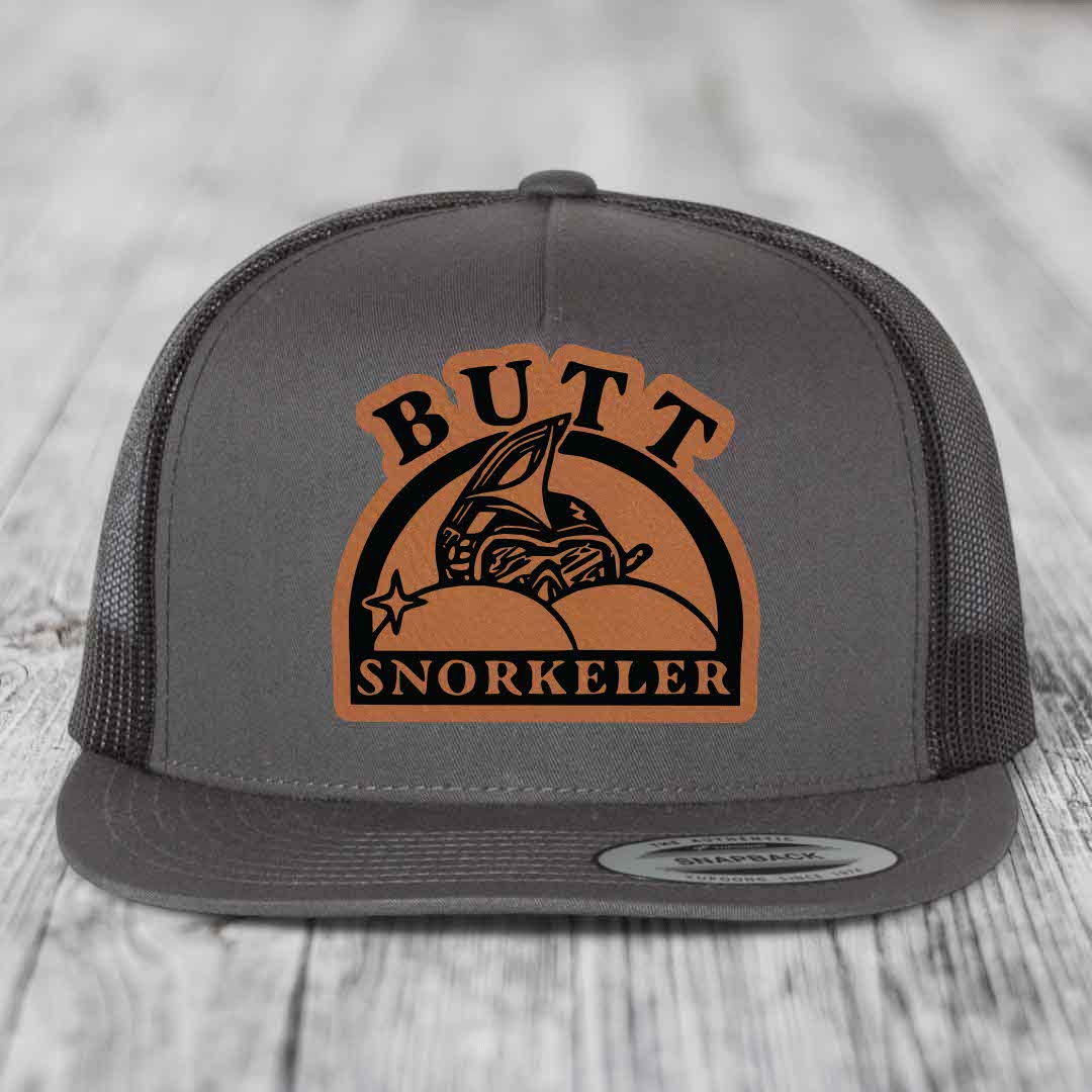 Grey trucker hat with brown leather patch reading &