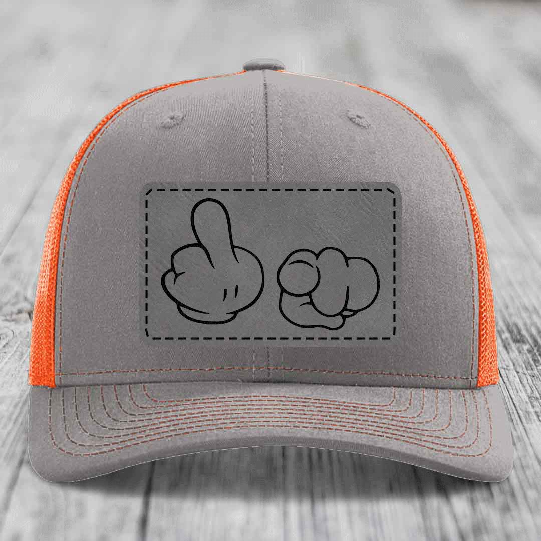 Grey trucker hat with orange mesh and a black leatherette patch showing cartoon hands making rude gestures.