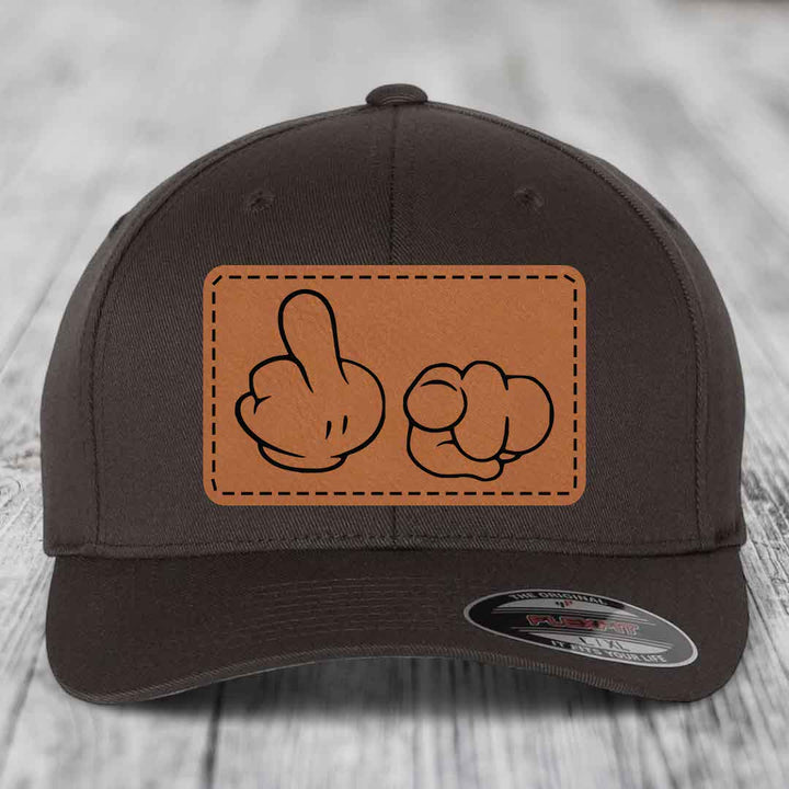 Dark brown baseball cap with a tan leatherette patch showing cartoon hands making a rude gesture.