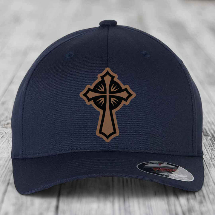 Dark blue baseball cap with a brown and black cross leather patch on front.
