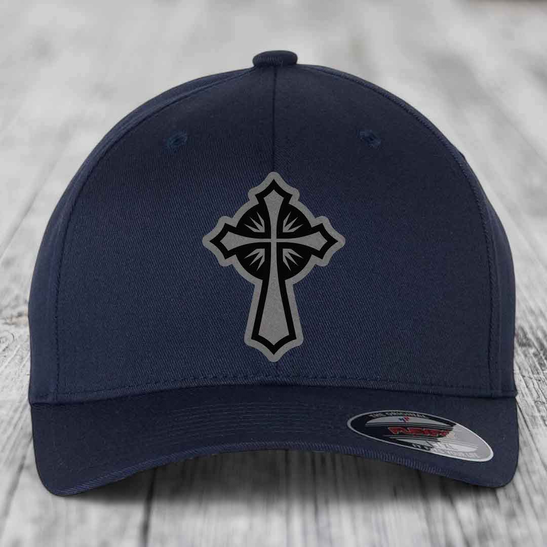Dark blue baseball cap with a grey and black cross patch on the front.