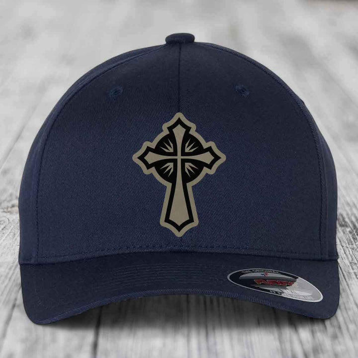 Dark blue baseball cap with a beige and black cross patch on the front.
