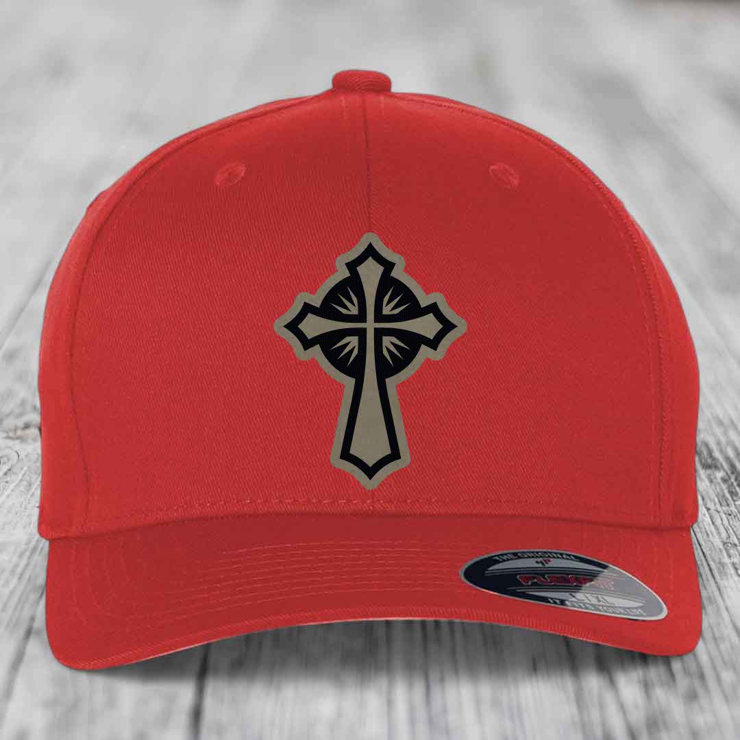 Red baseball cap with black and beige cross patch on front, Flexfit label visible.