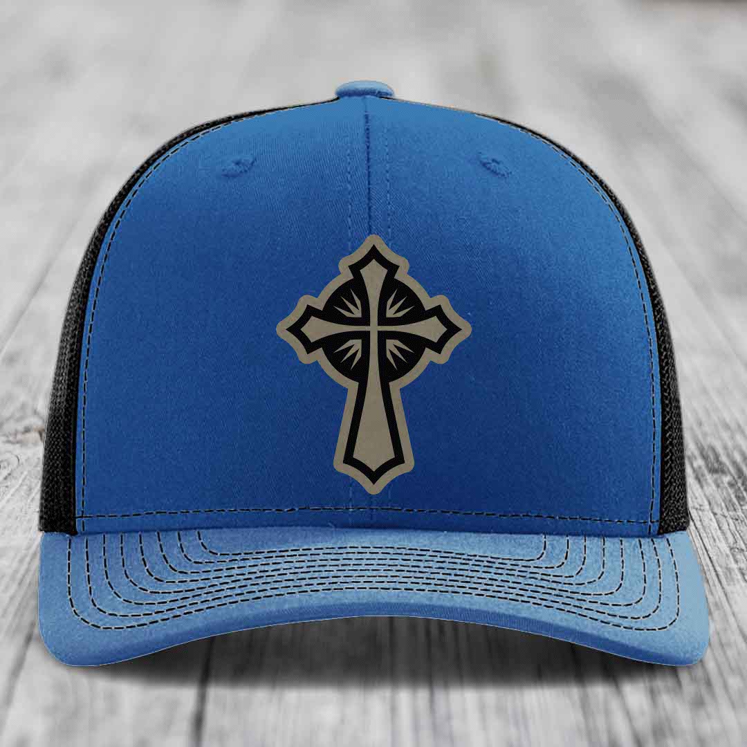 Blue trucker hat with black mesh back and a grey cross patch on front.
