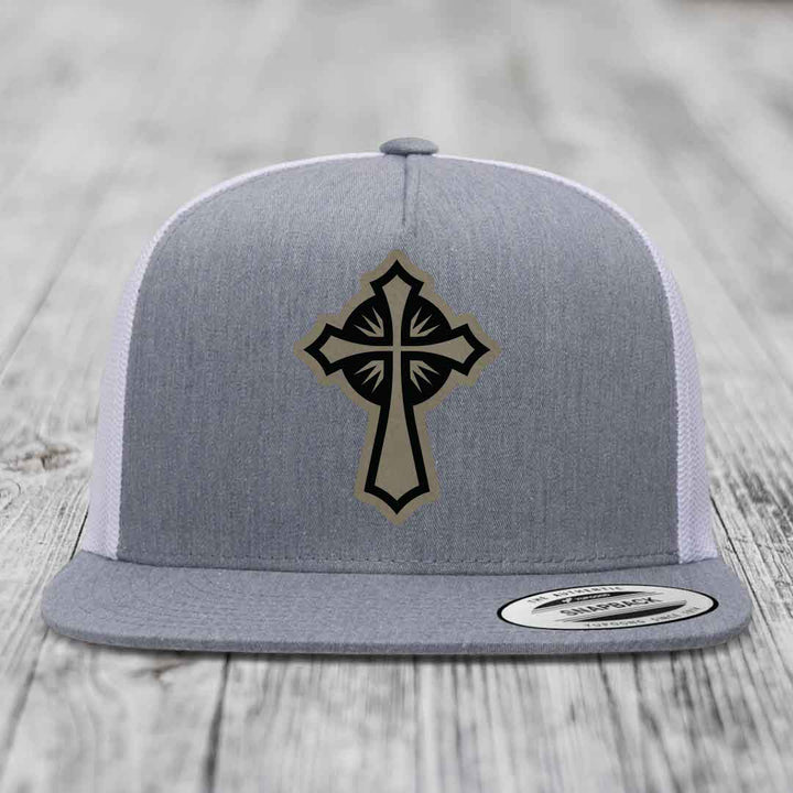 Grey snapback hat with black and tan cross patch on front, white mesh back.